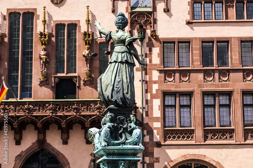 statue of lady justice in front of the roemer in frankfurt