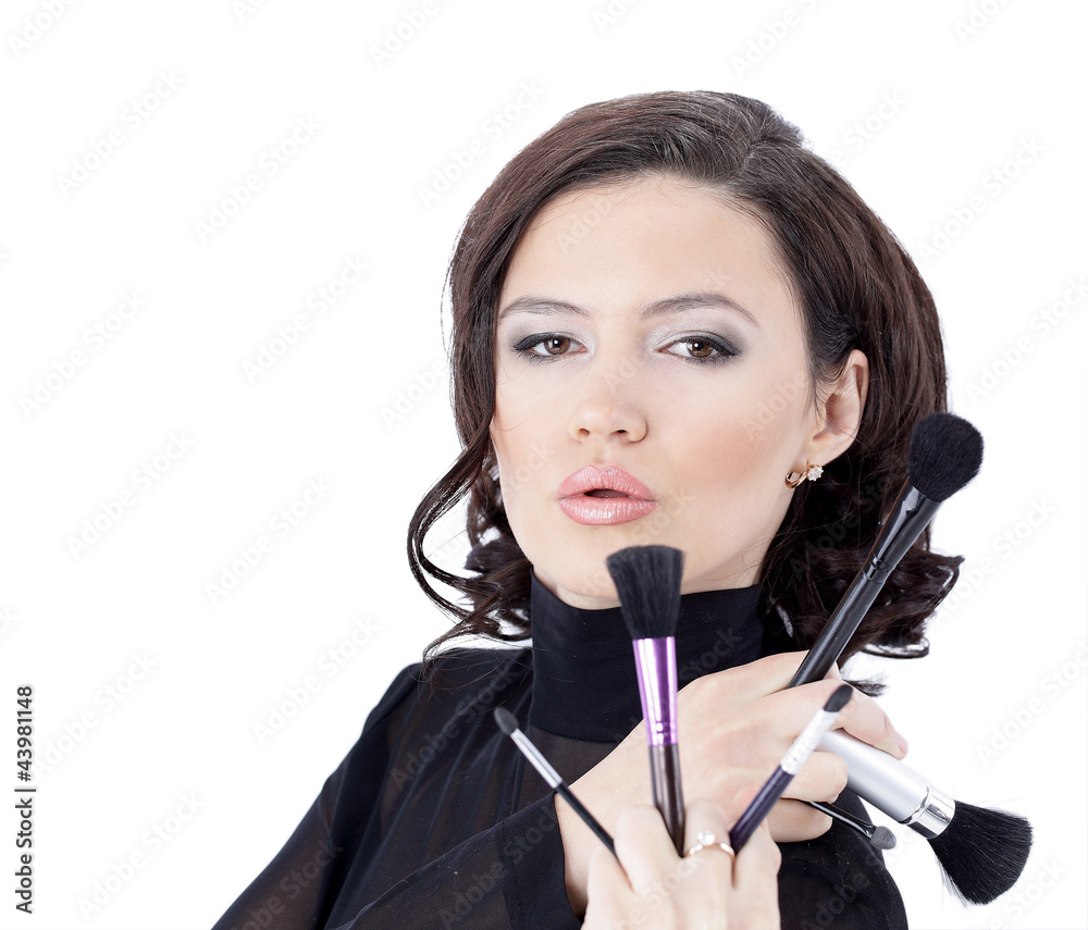 Obraz premium Beautiful woman with makeup brush near her face