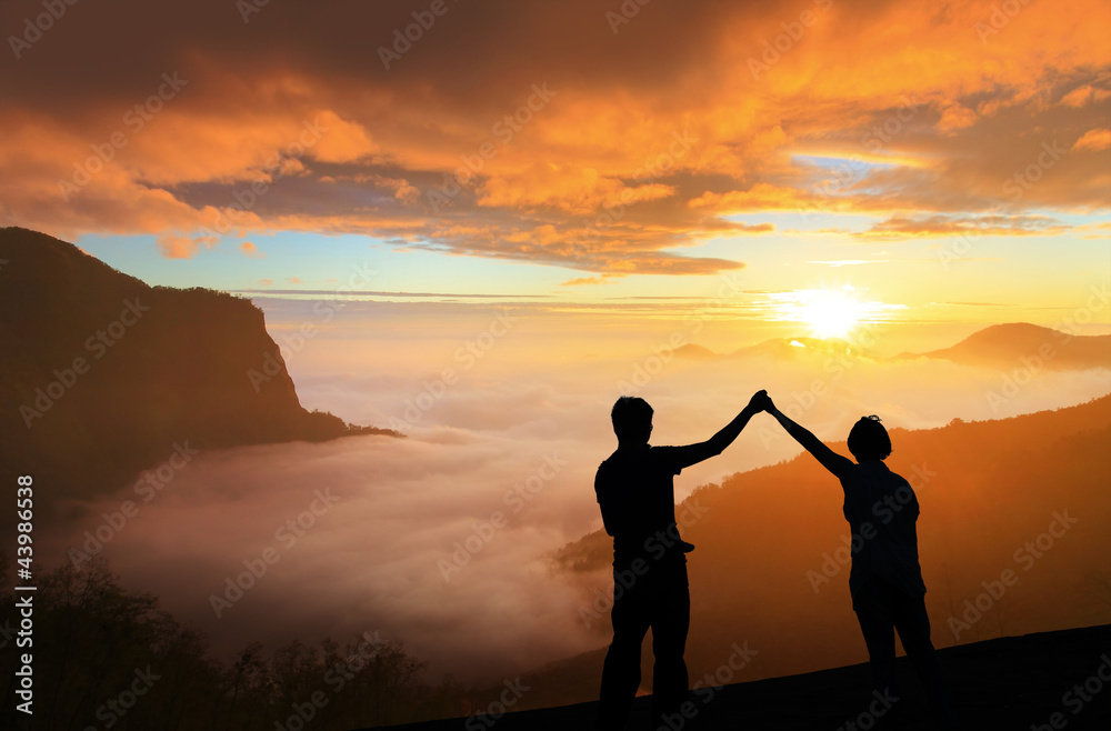Fototapeta premium silhouette of Young family happy look sunrise
