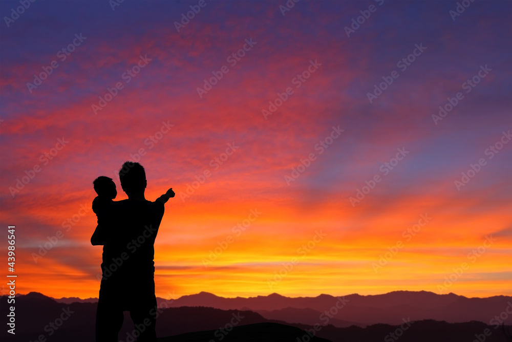 silhouette of Father and child watching the sunrise