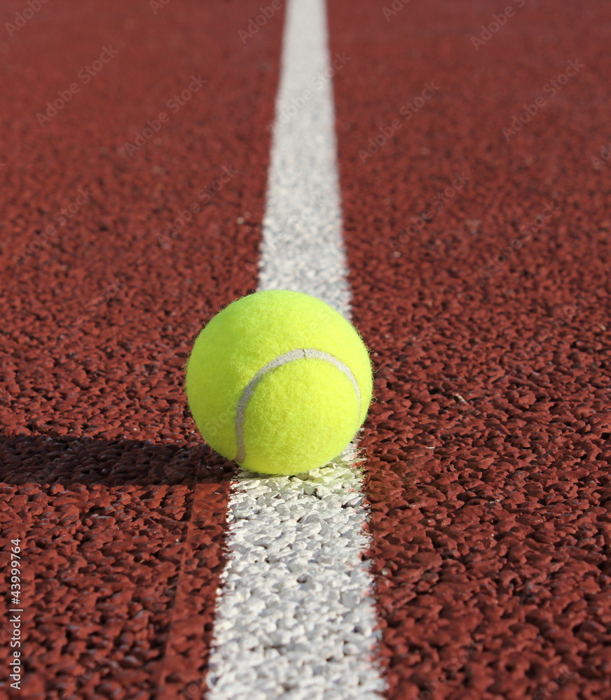 tennis ball on white line