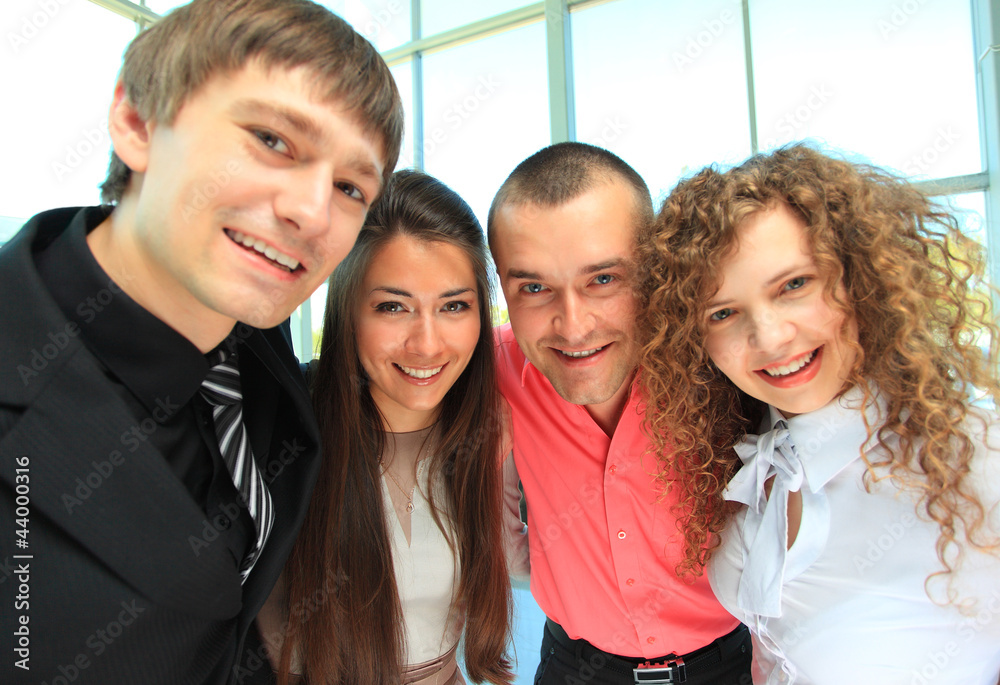 Closeup portrait of a successful business team laughing together Closeup portrait of a successful business team laughing together