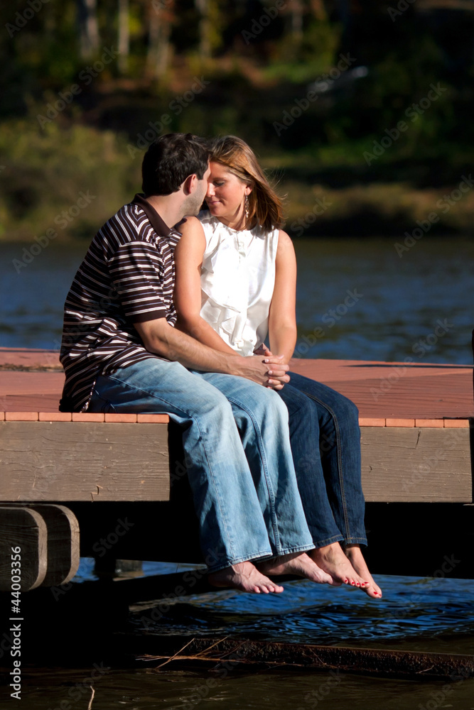 Romantic Couple Share An Intimate Moment Barefoot At Lake
