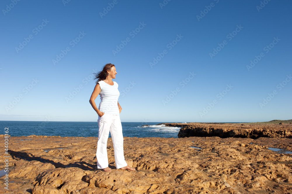 Happy confident woman at ocean background