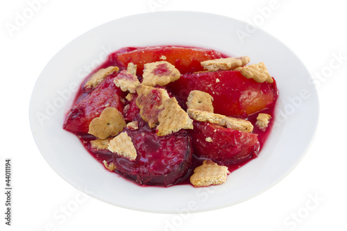 baked fruits with cookies on the white plate