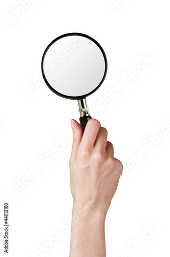 Magnifier glass in woman hand isolated on white