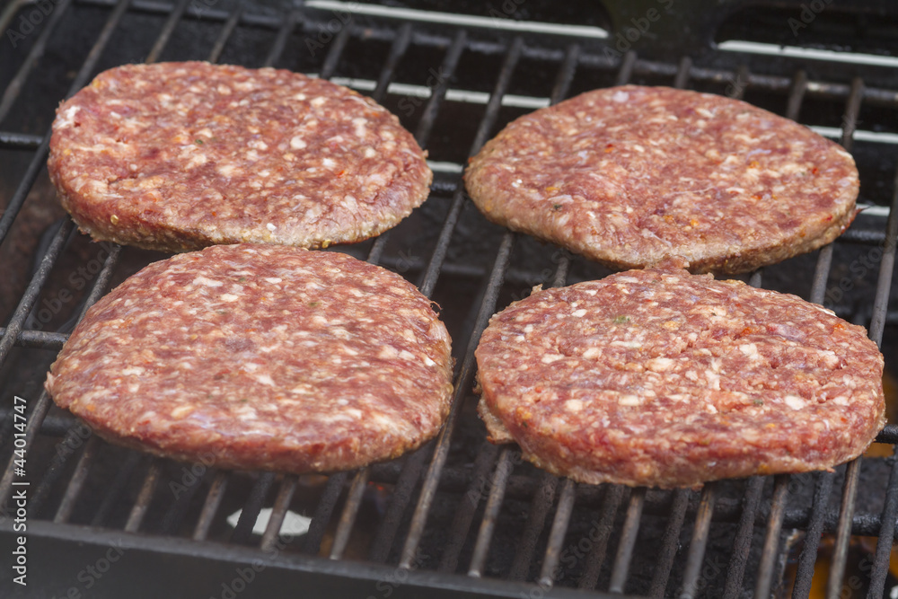 Raw Burgers on a Barbecue Raw Burgers on a Barbecue
