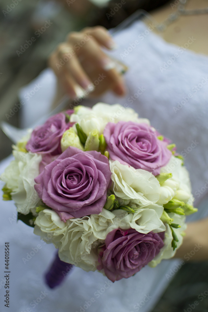 Bride holding an elegant bouquet or bunch of flowers Bride holding an elegant bouquet or bunch of flowers