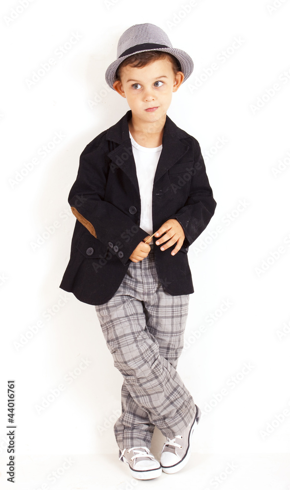 Pensive cool pretty stylish little boy on white background