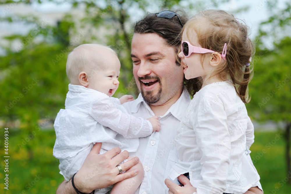 Fototapeta premium Young father and his two daughters