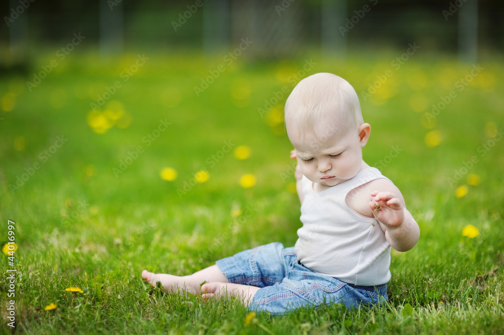 Baby sitting on green grass Baby sitting on green grass