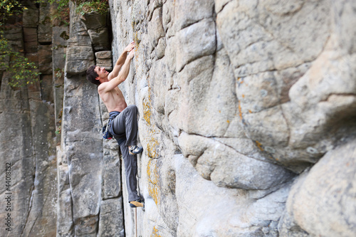 Rock climber struggling to make the next movement