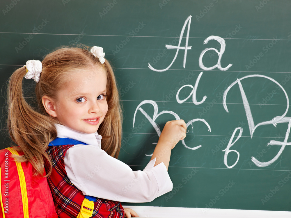 Schoolchild writting on blackboard