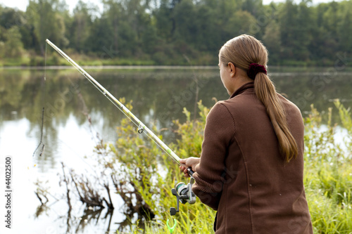 fisherman checks fishing rod