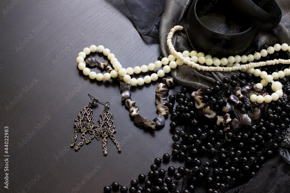 Jewels and the earrings on a wooden table