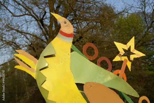 Yellow-green metal bird with a star