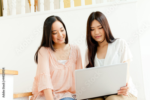 Beautiful young business women using a laptop. Portrait of asian