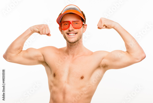 CLoseup of attractive young man flexing bicep muscles on white b