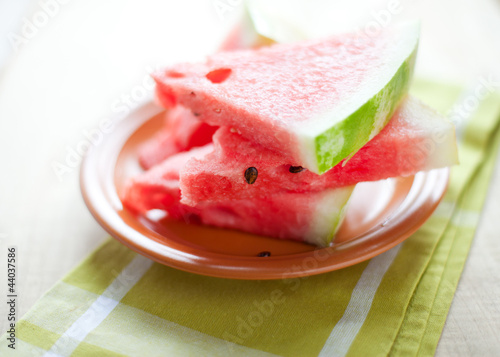 Watermelon on the brown circular plate