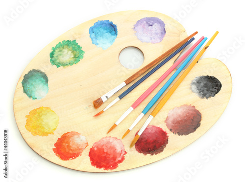 wooden art palette with paint and brushes isolated on white