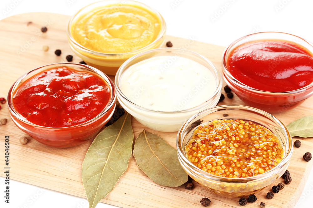 various sauces on chopping board close-up various sauces on chopping board close-up