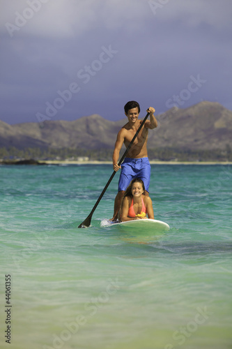 couple on standup paddle board in hawaii