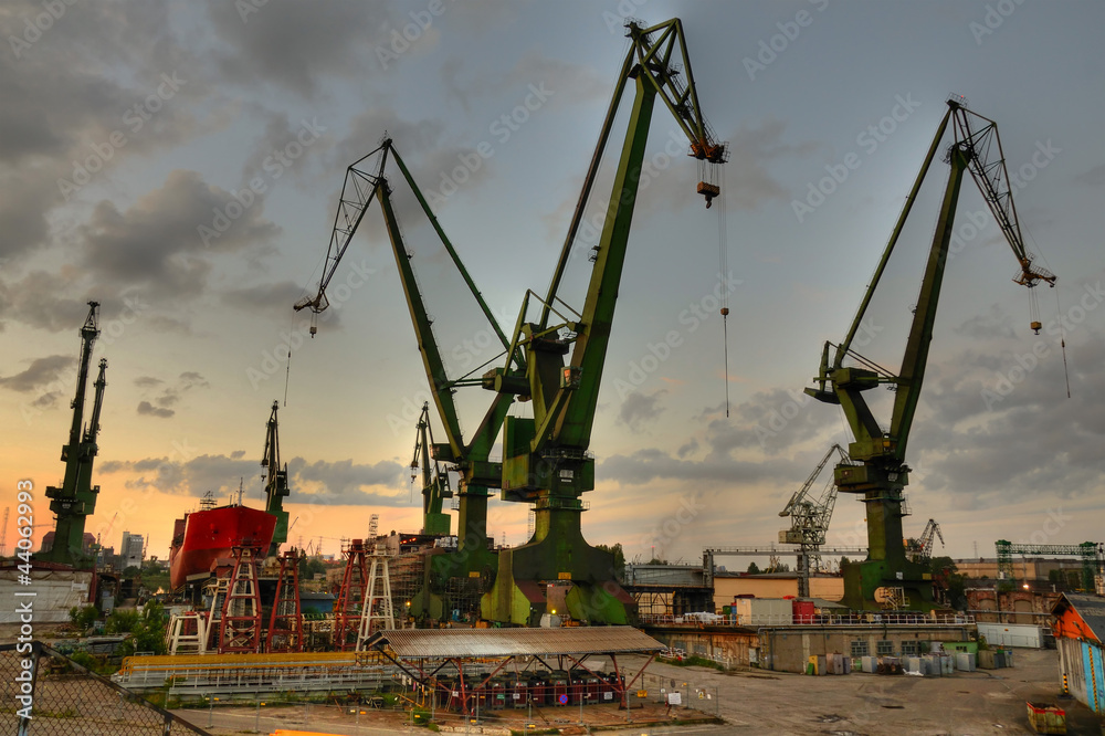 Fotografie, Obraz Gdansk shipyard cranes at summer evening