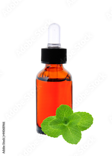bottle with essence oil and mint herb isolated on white