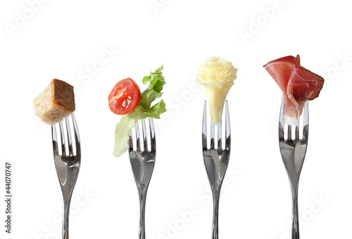 Food on forks: bread, vegetable, cheese and meat