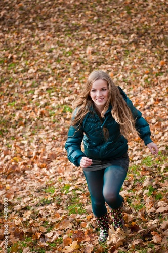Autumn pleasure - young woman runing