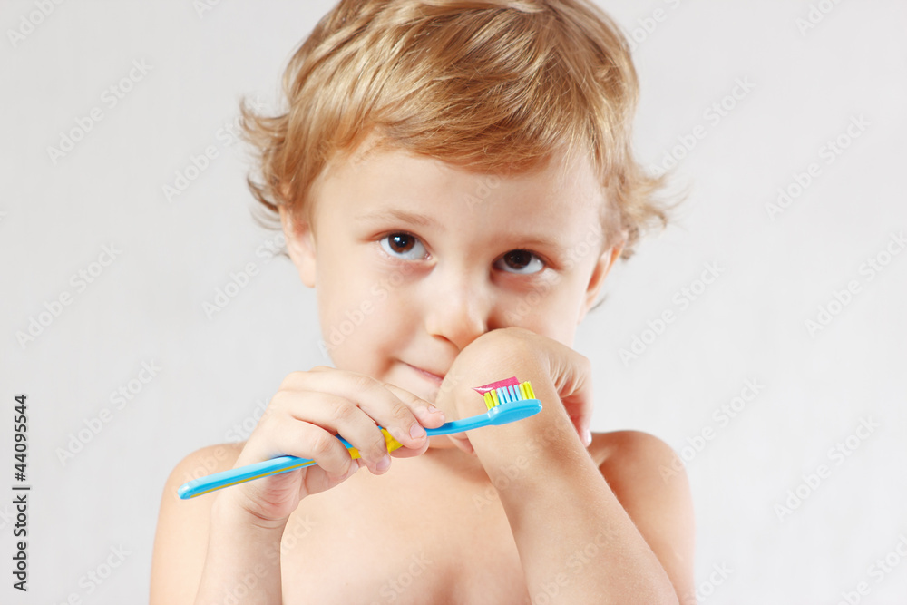 Little cute blond boy with toothbrush with pink toothpaste Little cute blond boy with toothbrush with pink toothpaste