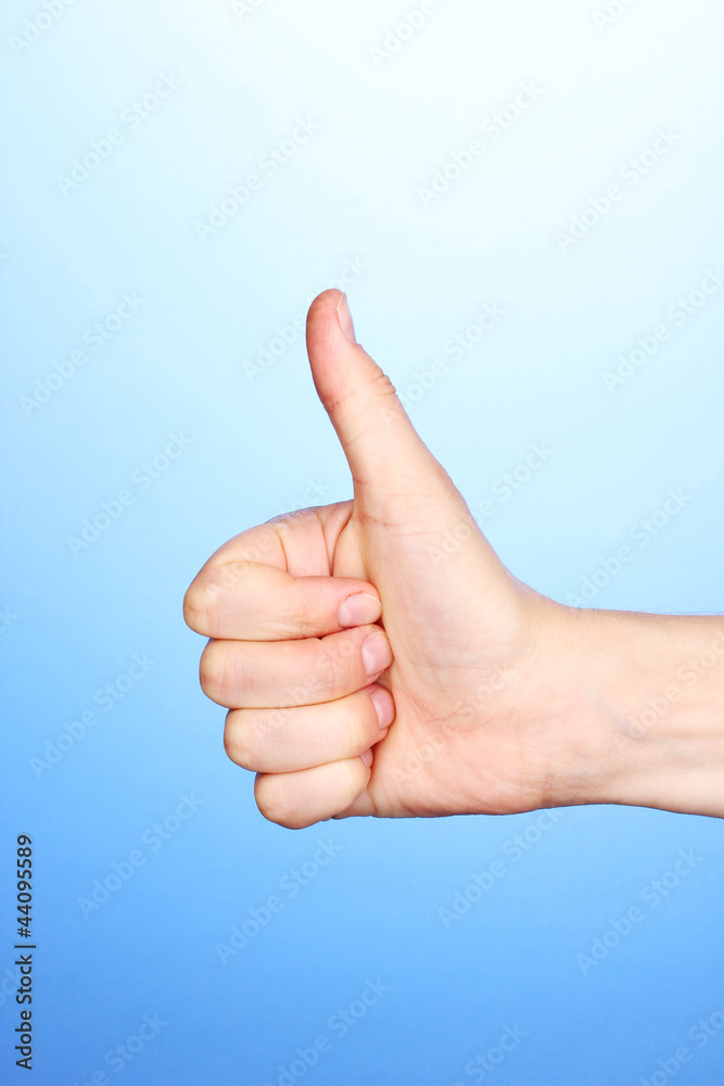 Hand making sign on blue background Hand making sign on blue background