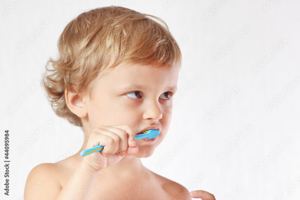 Young cute blond boy brushing his teeth Young cute blond boy brushing his teeth
