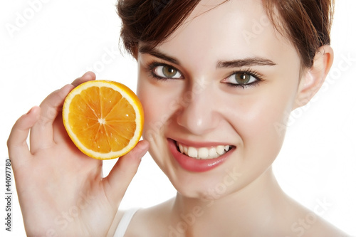 happy young woman with orange isolated on white background