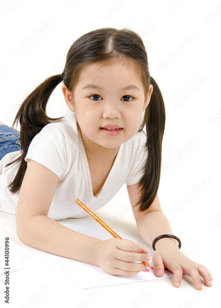 A young asian girl drawing a picture. On white A young asian girl drawing a picture. On white