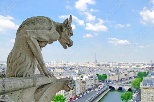 Gargoyle in Notre Dame, Eiffel Tower on back. Paris, France © stevanzz
