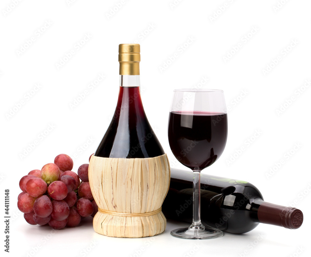 Full red wine glass goblet, bottle and grapes
