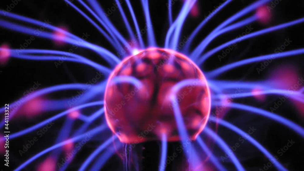 Plasma ball with moving energy rays inside on black background