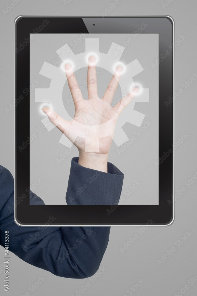 Hand pushing gear icon tablet on a touch screen blank interface Hand pushing gear icon tablet on a touch screen blank interface