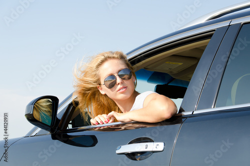 Woman looking back from the car window