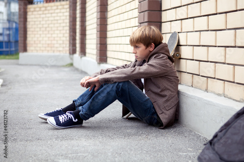 School teen with scholbag and skateboard