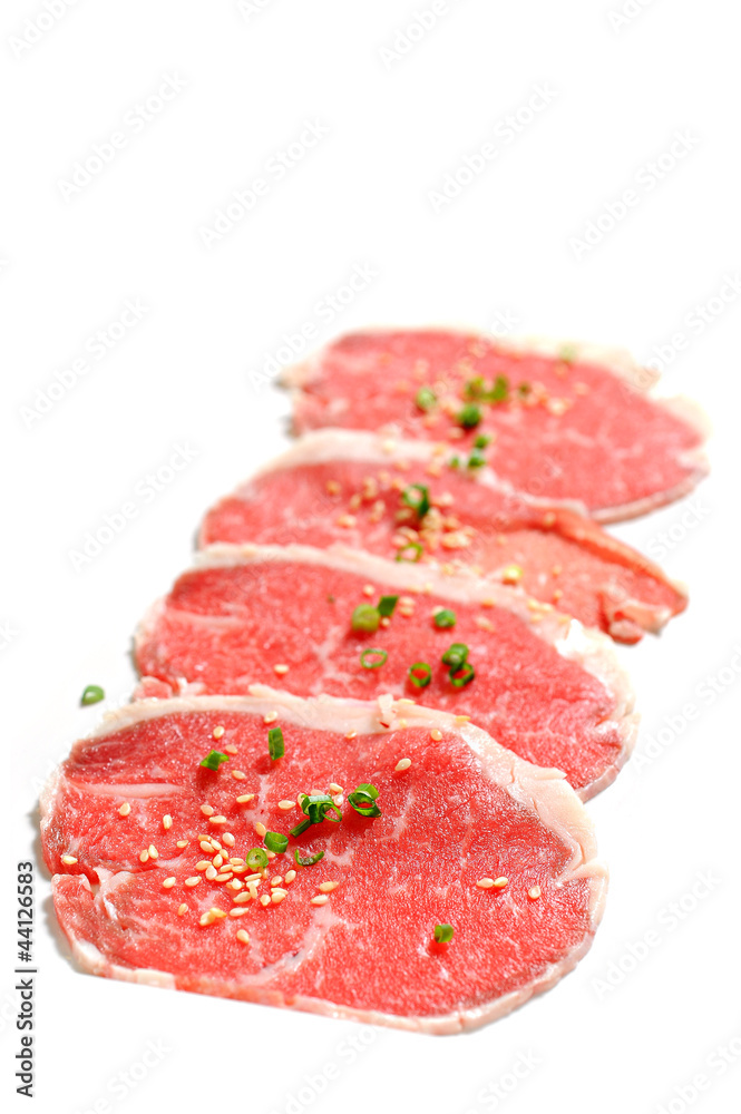 Beef slices isolated on white background with sesame and Onion Beef slices isolated on white background with sesame and Onion
