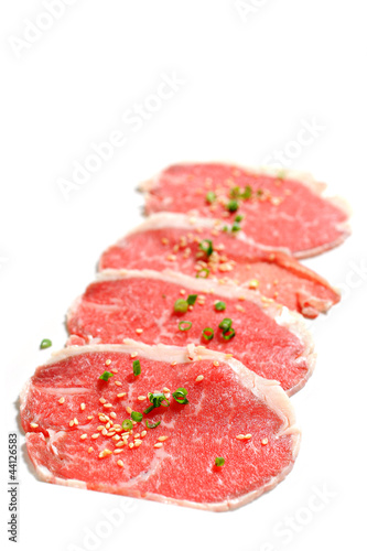 Beef slices isolated on white background with sesame and Onion