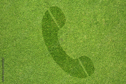 Phone icon on green grass texture and  background