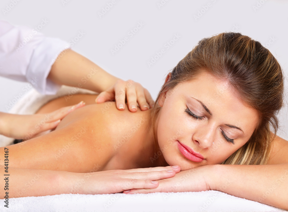 An attractive woman getting spa treatment, isolated on white An attractive woman getting spa treatment, isolated on white