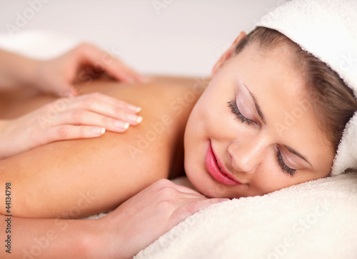 An attractive woman getting spa treatment, isolated on white