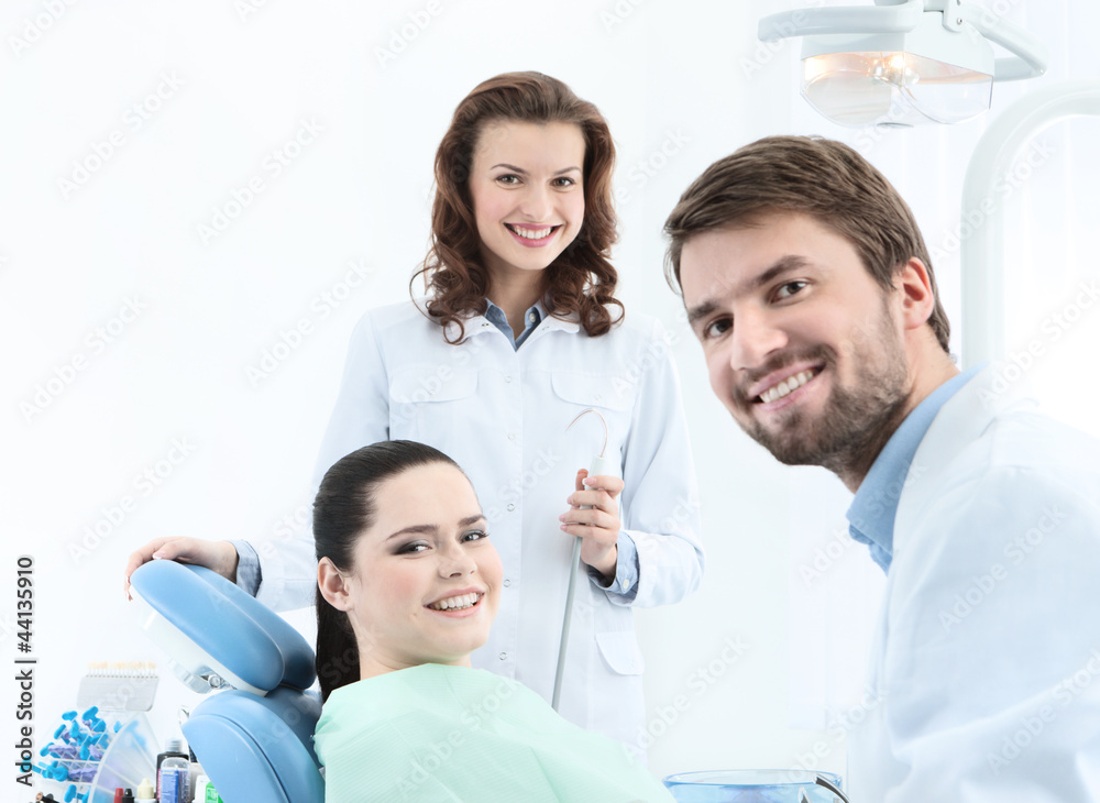 Obraz premium Dentist, his assistant and the patient