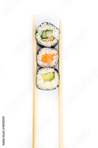 Row of sushi rolls with chopsticks, isolated