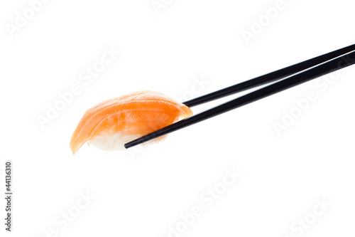 Sushi nigiri with chopsticks, isolated on white