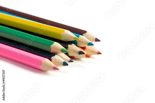 Color pencils over white background